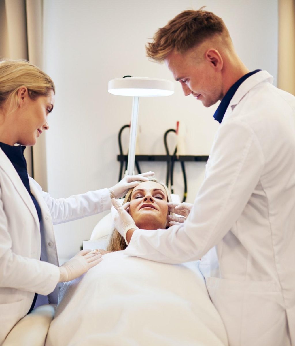 doctors-discussing-cosmetic-surgery-options-over-a-client.jpg